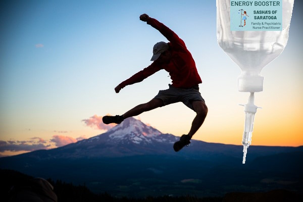 Energy Boost - man leaping into air in front of mountain