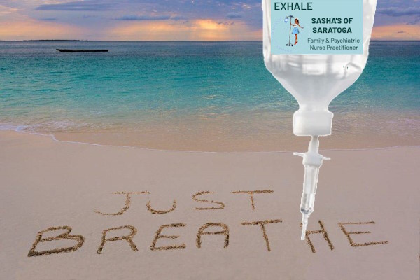 Exhale - beach with "Just Breathe" written in sand