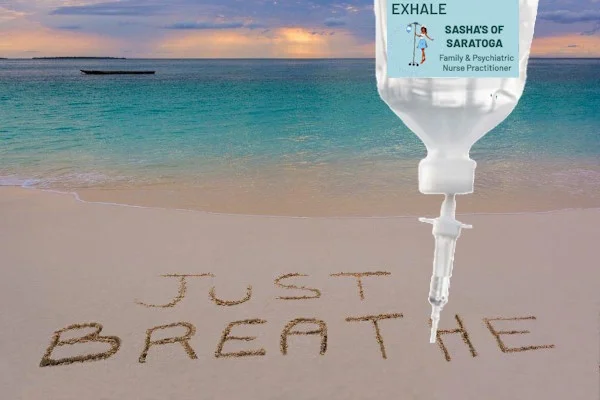 Exhale - beach with "Just Breathe" written in sand