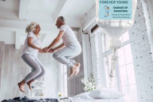 Forever Young (image of older couple jumping on bed)