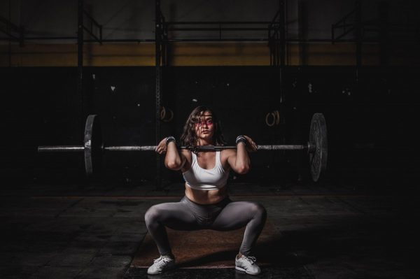 Woman squatting and lifting weights